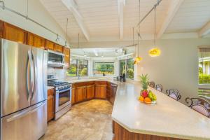 a kitchen with wooden cabinets and stainless steel appliances at Mala Hale in Princeville