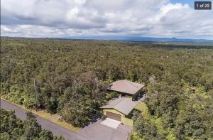 an overhead view of a house in the middle of a forest at Volcano One - Modern Studio with Lanai near Volcano National Park in Volcano