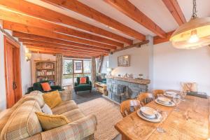 a living room with a couch and a table at Byre Cottage Woodland Coniston in Torver