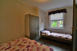 a bedroom with two beds and a window at Apartamenty PRIMA in Rewal