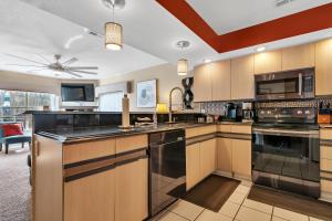 a large kitchen with wooden cabinets and a ceiling fan at Family Friendly condo at Diamond Resorts! in Branson