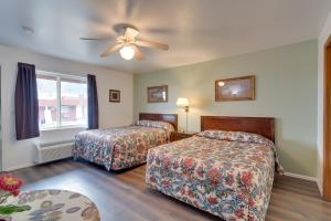 a hotel room with two beds and a ceiling fan at Loveland Vacation Rental Pets Welcome in Loveland