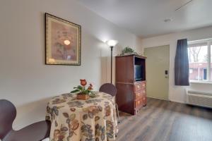 a room with a table and a dresser and a television at Loveland Vacation Rental Pets Welcome in Loveland