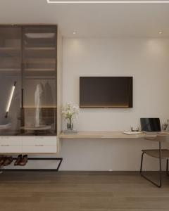 a living room with a tv on a white wall at Moov 1417 Studio Mooca in Sao Paulo