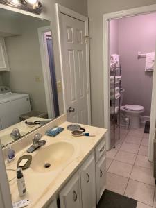 a bathroom with a sink and a large mirror at Creek View Townhome in Augusta