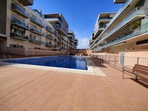 a swimming pool in the middle of a building at Badalona Beach Apartment in Badalona