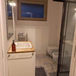 a bathroom with a sink and a toilet at B&B Tantané in Torgnon +6 photos