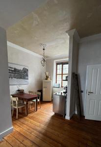 eine Küche und ein Esszimmer mit einem Tisch und einem Kühlschrank in der Unterkunft Belle Époque in Solingen