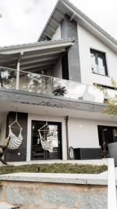 a house with two hammocks hanging from the windows at FeWo-Seefunkeln in Diensdorf am Scharmützelsee in Diensdorf-Radlow