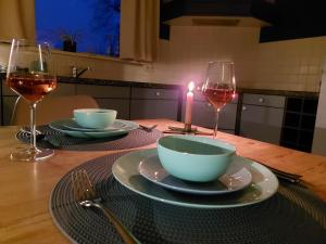 AkkrumにあるLuxe gastenverblijf in het hart van Frieslandのキャンドル付きテーブル、ワイン2杯