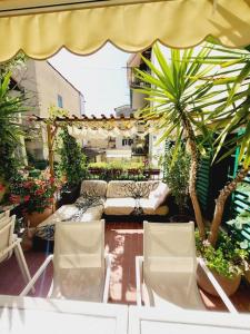 a patio with two chairs and an umbrella and plants at Florencia Luxury Apartament in Florence