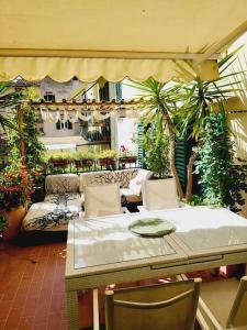 a patio with a table and chairs and plants at Florencia Luxury Apartament in Florence