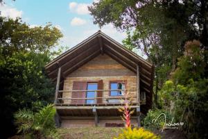 a small house with a window on the side of it at Pousada Aceguá in Praia Grande +23 photos