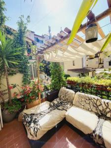 a patio with a couch and an umbrella at Florencia Luxury Apartament in Florence