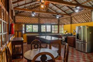 een keuken met een tafel en een koelkast bij Casa Hacienda El Menco in Rivas