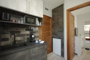 A kitchen or kitchenette at Paradiso Apartmanház