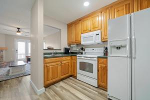 a kitchen with white appliances and wooden cabinets at Nacoochee in Helen
