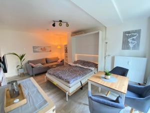 a living room with a bed and a couch at Ferienwohnung Sternenhimmel in Lichtenberg