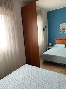 a bedroom with a bed and a window and a bedskirts at Apartment Fabiola in Sistiana