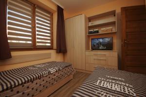 A bed or beds in a room at Paradiso Apartmanház