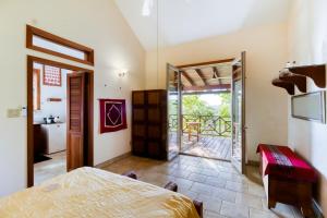 a bedroom with a bed and a door to a balcony at Punta Studio at Framadani Estate in San Ignacio