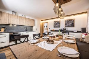 a kitchen and dining room with a table and chairs at Oberhaslachhof in Reith im Alpbachtal