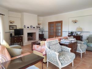 a living room filled with furniture and a fireplace at Sweet Home Lux Villa Vau in Portimão