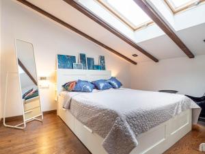 a bedroom with a large bed with blue pillows at Apartament Bocheńska in Krakow