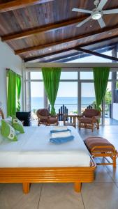 a bedroom with a bed with a view of the ocean at Kayu Surf Resort in La Libertad