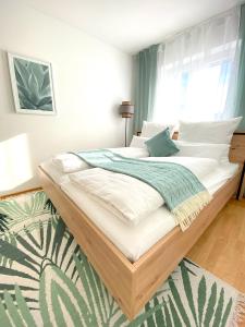 a bedroom with a large bed with white sheets at RONI APARTMENTS -111qm Luxury Loft -Near Center and Clinics -Netflix -Terrace -Close to Thermal Spa in Bad Aibling
