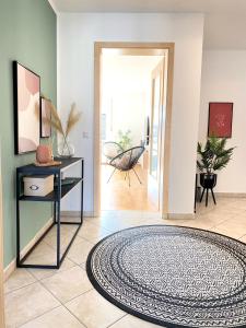 a hallway with a rug on the floor at RONI APARTMENTS -111qm Luxury Loft -Near Center and Clinics -Netflix -Terrace -Close to Thermal Spa in Bad Aibling