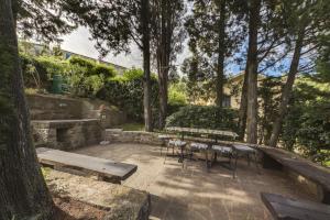 a patio with tables and chairs in a park at Luxury Apartments PORTO, free parking in Portorož