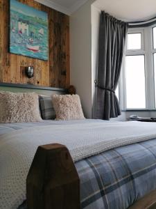 a bedroom with a large bed and a window at Pensalda Guest House in Newquay