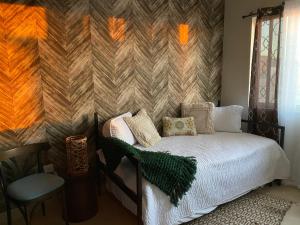 a bedroom with a bed and a wooden wall at Beautiful house at Rosarito beach in San Antonio del Mar