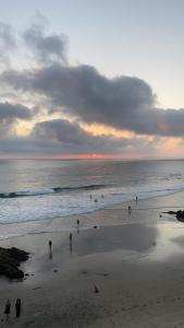 a group of people walking on the beach at Beautiful house at Rosarito beach in San Antonio del Mar