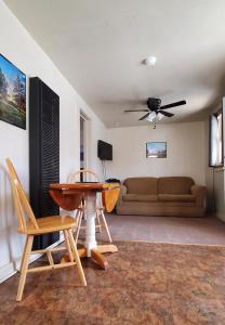 a living room with a couch and a table and chairs at Hikers Cimarron Inn & RV Park in Cimarron