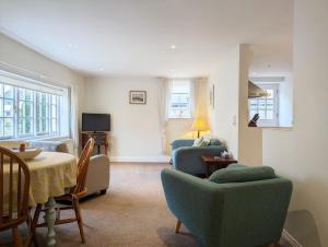 a living room with two chairs and a table at Flint Cottage , Emsworth in Emsworth