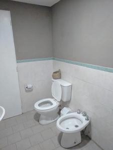 a bathroom with a toilet and a sink at Casa Quinta Las Casuarinas in Mercedes