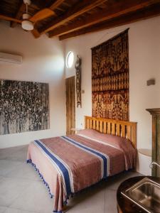 a bedroom with a bed and a sink at Casa de la Luna in Puerto Escondido