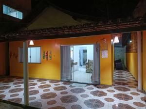 um quarto com uma parede amarela e uma porta de vidro em Casa Temporada Prado-BA em Prado
