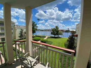 a balcony with chairs and a view of the water at Disney's Saratoga Springs Resort and Spa in Orlando