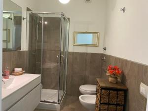 a bathroom with a shower and a toilet and a sink at relax home in Marsala