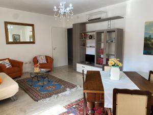 a living room with a dining table and a living room with a couch at relax home in Marsala