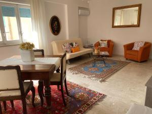a living room with a table and a couch at relax home in Marsala