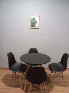 a table and four chairs in a room at Apartamento encantador in Belo Horizonte