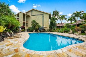 a swimming pool in front of a house at Kalanikai 306 in Kailua-Kona