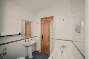 een badkamer met een wastafel, een toilet en een douche bij Santaia en Casal de Calma in O Pedrouzo