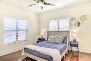 a bedroom with a bed and two windows at Stunning Jacksonville Getaway with Backyard! in Jacksonville