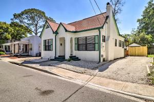 a white house with a green roof on a street at Stunning Jacksonville Getaway with Backyard! in Jacksonville