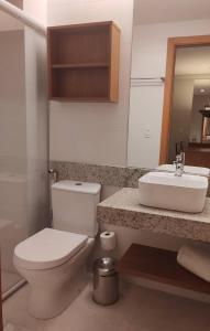 a bathroom with a toilet and a sink at Salinas Exclusive Resort in Salinópolis